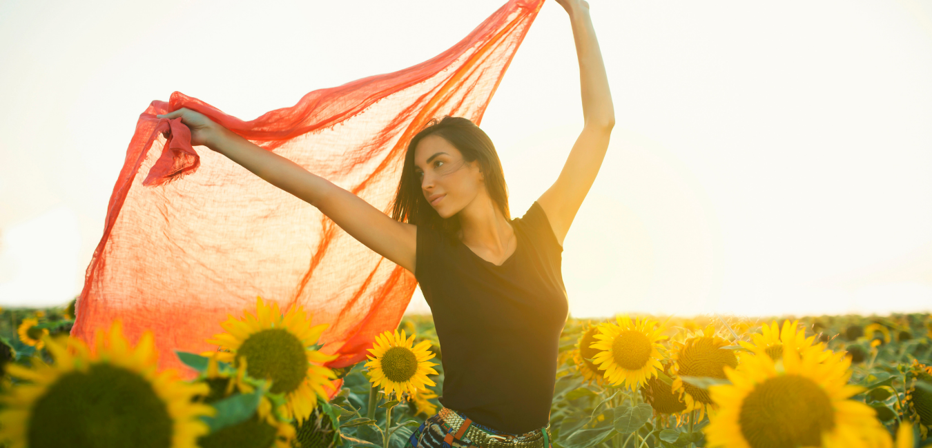 Girl with dupatta in sunflower field depicting "live in the moment"